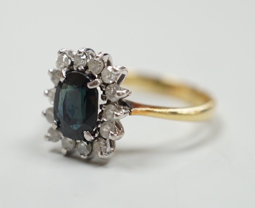 An 18k yellow metal, sapphire and diamond set rectangular cluster ring, size M, gross 4 grams.